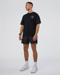 Man wearing GTC Heavyweight Oversized Tee - Black-Cantaloupe | Model:Nikola | Size:L