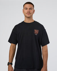 Man wearing GTC Heavyweight Oversized Tee - Black-Cantaloupe | Model:Nikola | Size:L