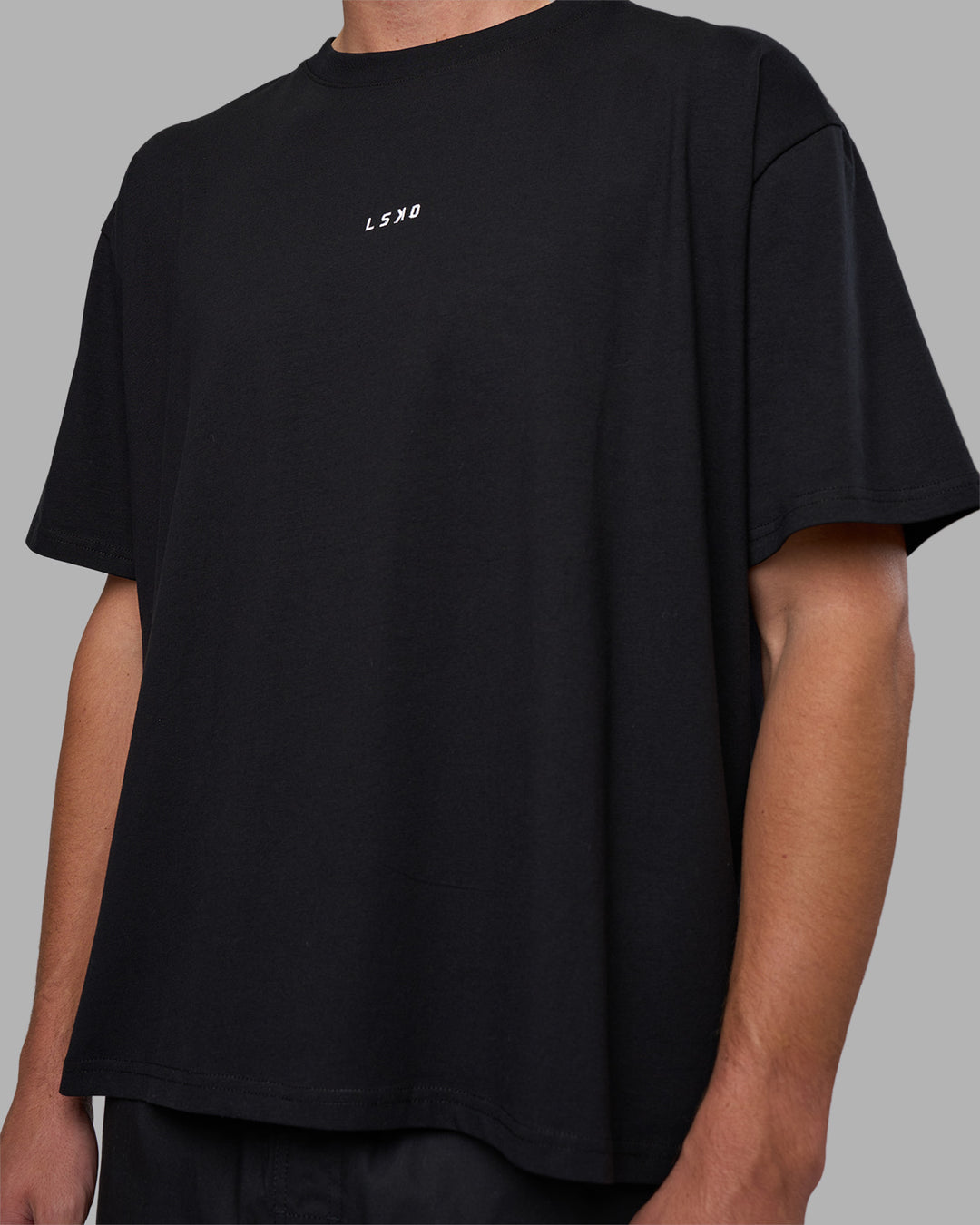 Man wearing Go-To FLXCotton Oversized Tee - Black-White | Model:Brandon | Size:L