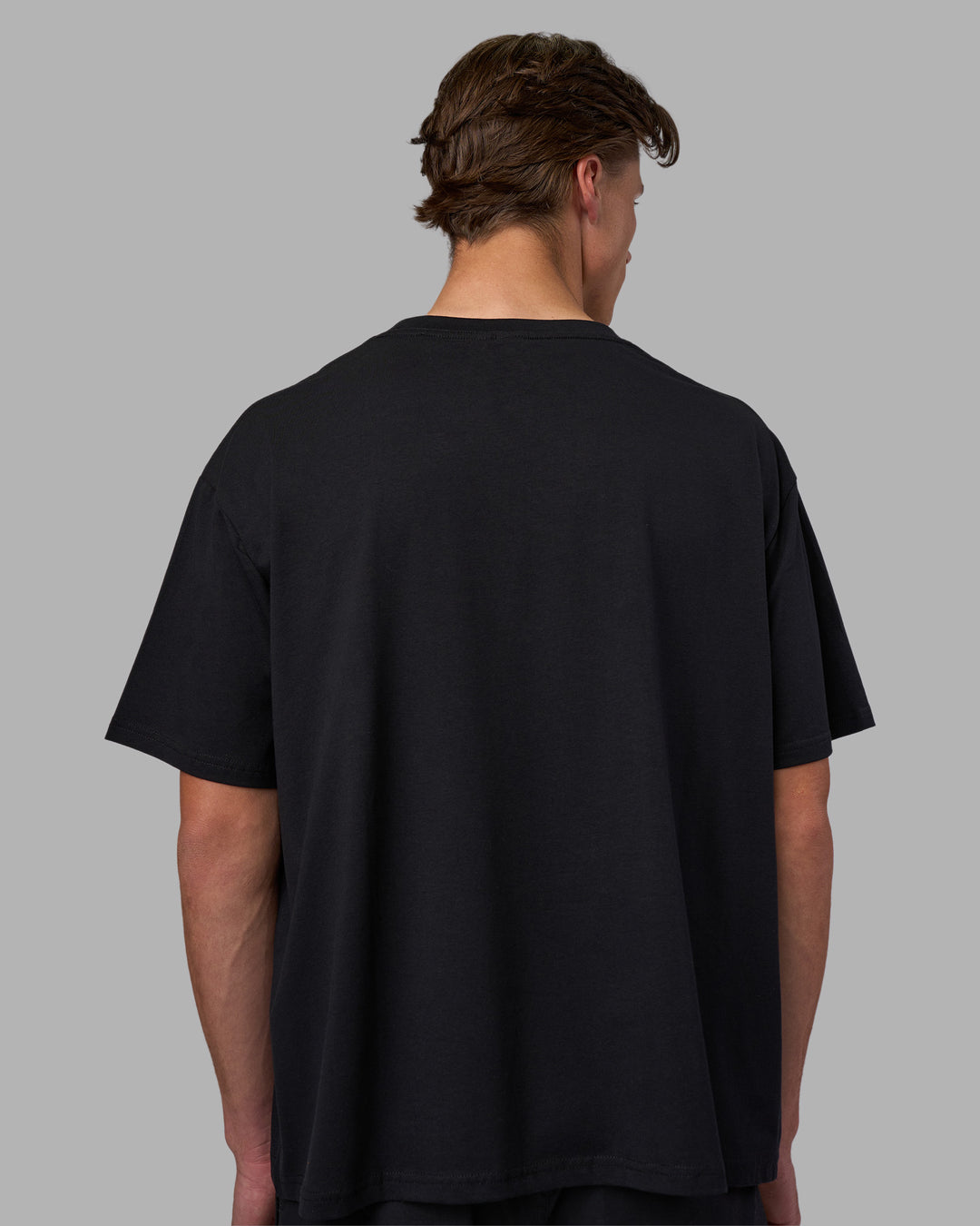Man wearing Go-To FLXCotton Oversized Tee - Black-White | Model:Brandon | Size:L