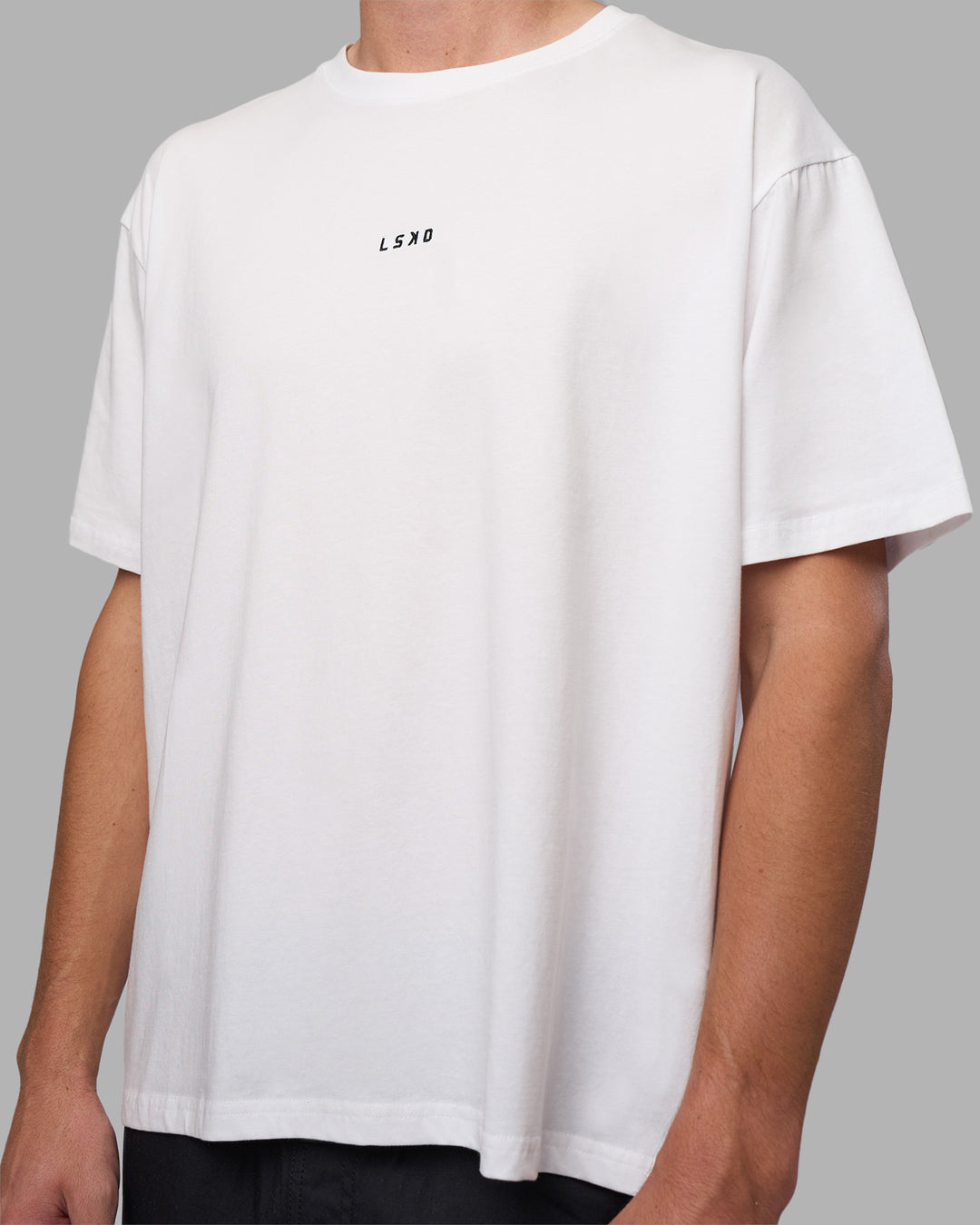 Man wearing Go-To FLXCotton Oversized Tee - White-Black | Model:Brandon | Size:L