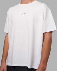 Man wearing Go-To FLXCotton Oversized Tee - White-Black | Model:Brandon | Size:L