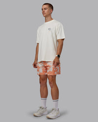 Man wearing Grand Slam 6" Shorts in Wildflower Cantaloupe | Size:L