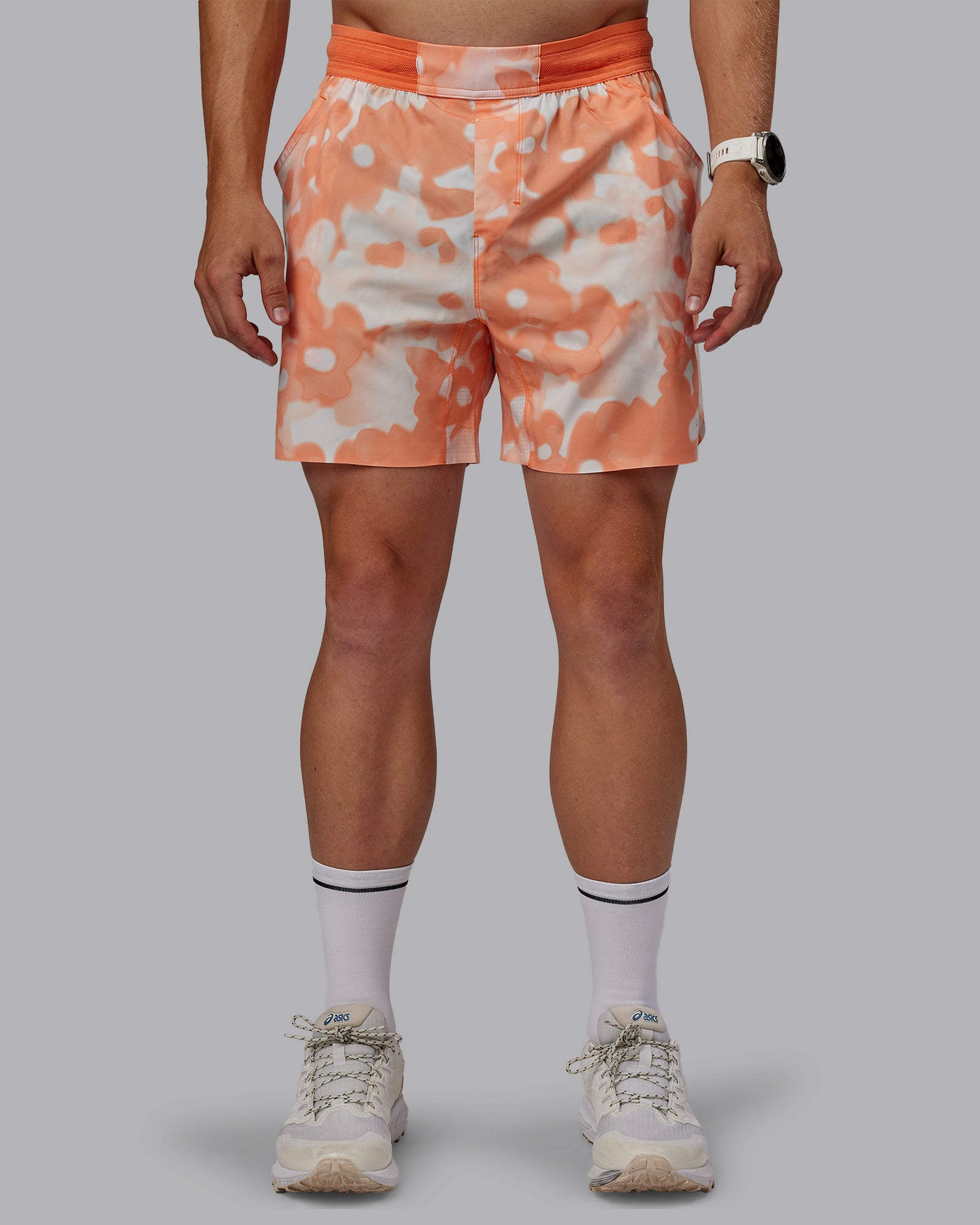 Man wearing Grand Slam 6" Shorts in Wildflower Cantaloupe | Size:L