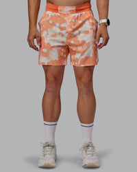 Man wearing Grand Slam 6" Shorts in Wildflower Cantaloupe | Size:L