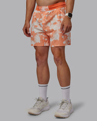 Man wearing Grand Slam 6" Shorts in Wildflower Cantaloupe | Size:L