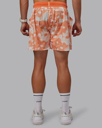 Man wearing Grand Slam 6" Shorts in Wildflower Cantaloupe | Size:L