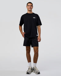 Man wearing Grid FLXCotton Oversized Tee - Black-White | Model:Zoran | Size:L