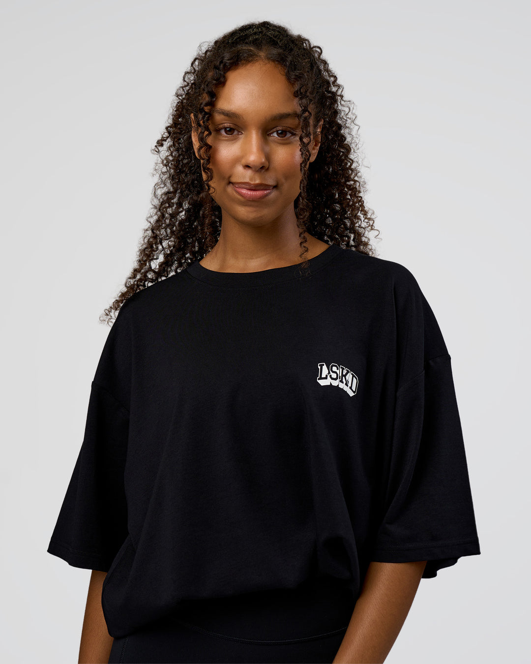 Woman wearing Grid FLXCotton Oversized Tee - Black-White | Model:Jordan | Size:L