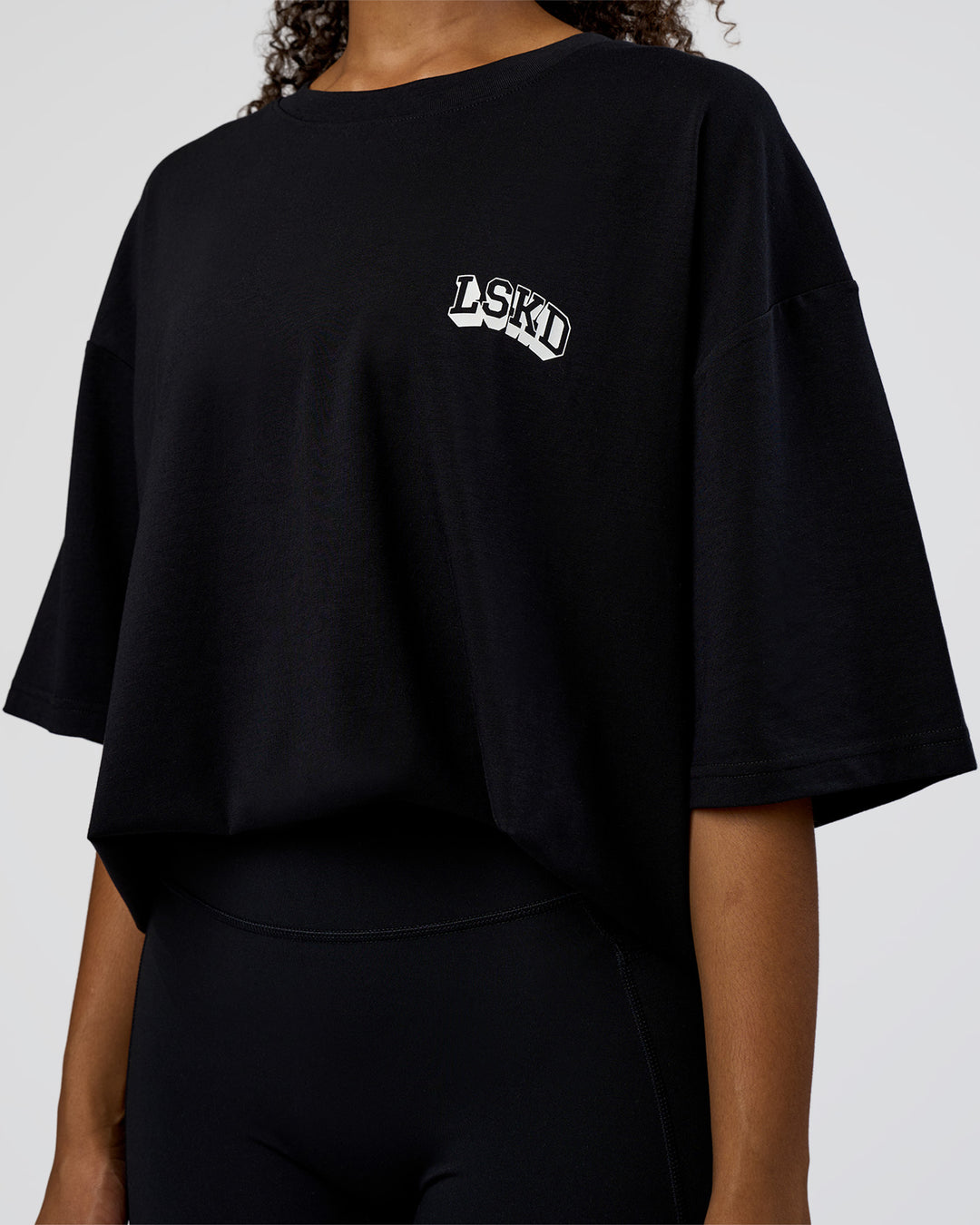 Woman wearing Grid FLXCotton Oversized Tee - Black-White | Model:Jordan | Size:L