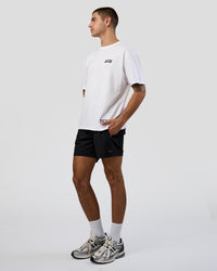 Man wearing Grid FLXCotton Oversized Tee - White-Black | Model:Zoran | Size:L