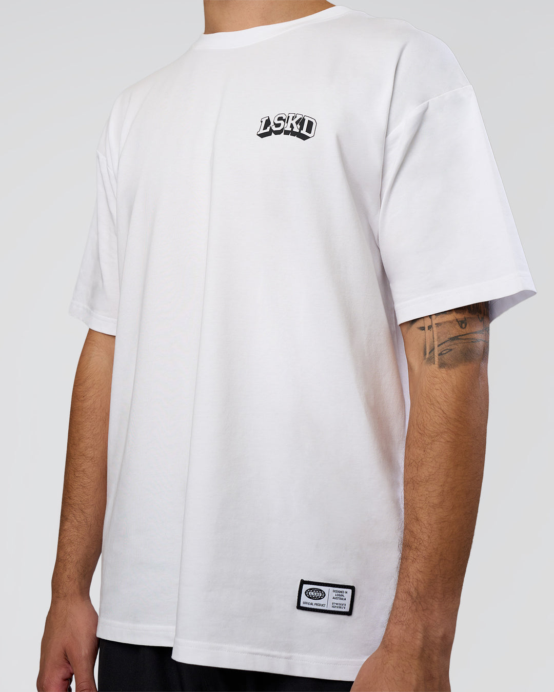 Man wearing Grid FLXCotton Oversized Tee - White-Black | Model:Zoran | Size:L