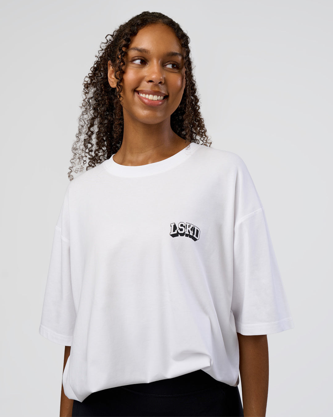 Woman wearing Grid FLXCotton Oversized Tee - White-Black | Model:Jordan | Size:L