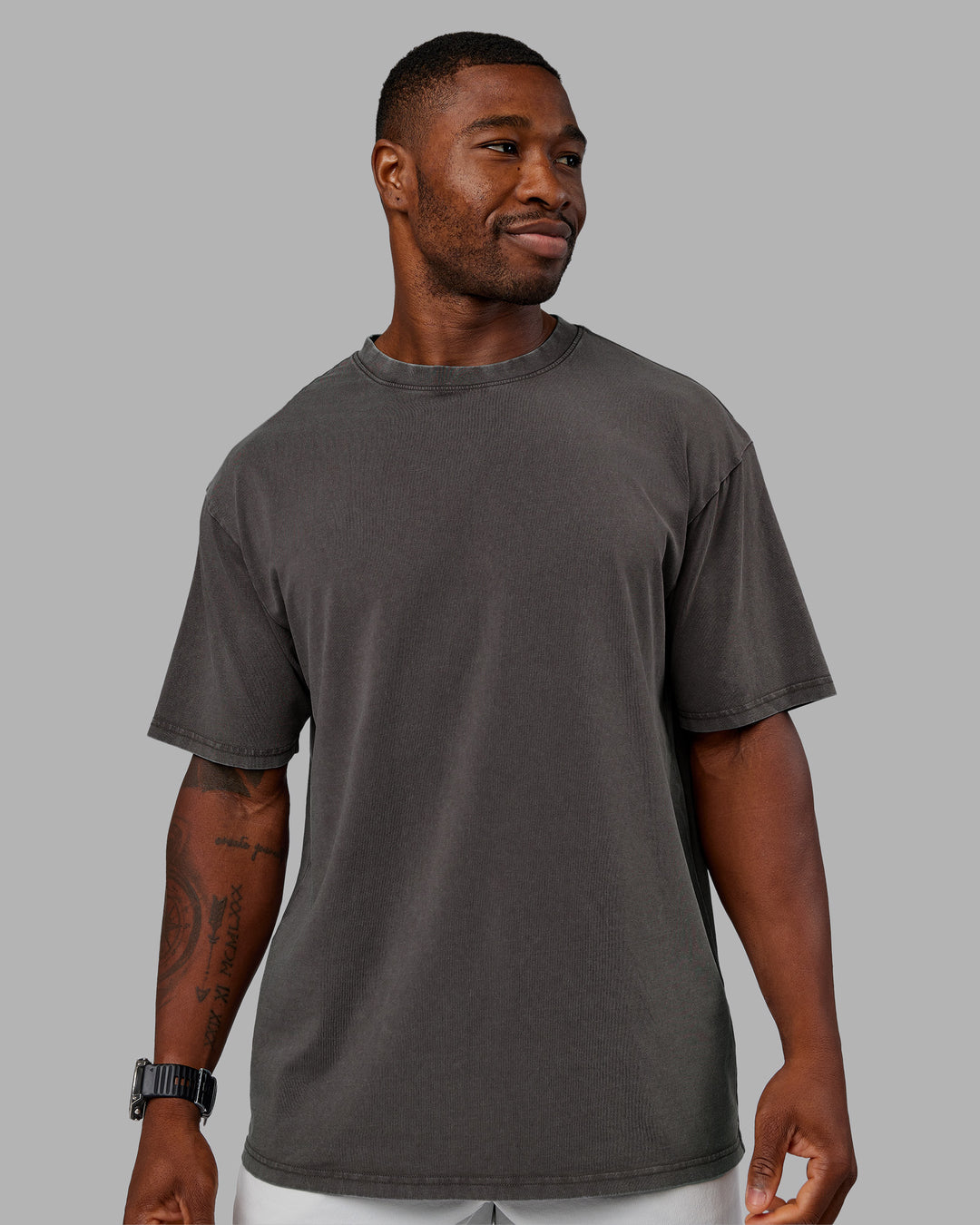 Man wearing Heart FLXCotton Oversized Tee - Washed Dark Storm-Violet Ray | Model:Sam | Size:L