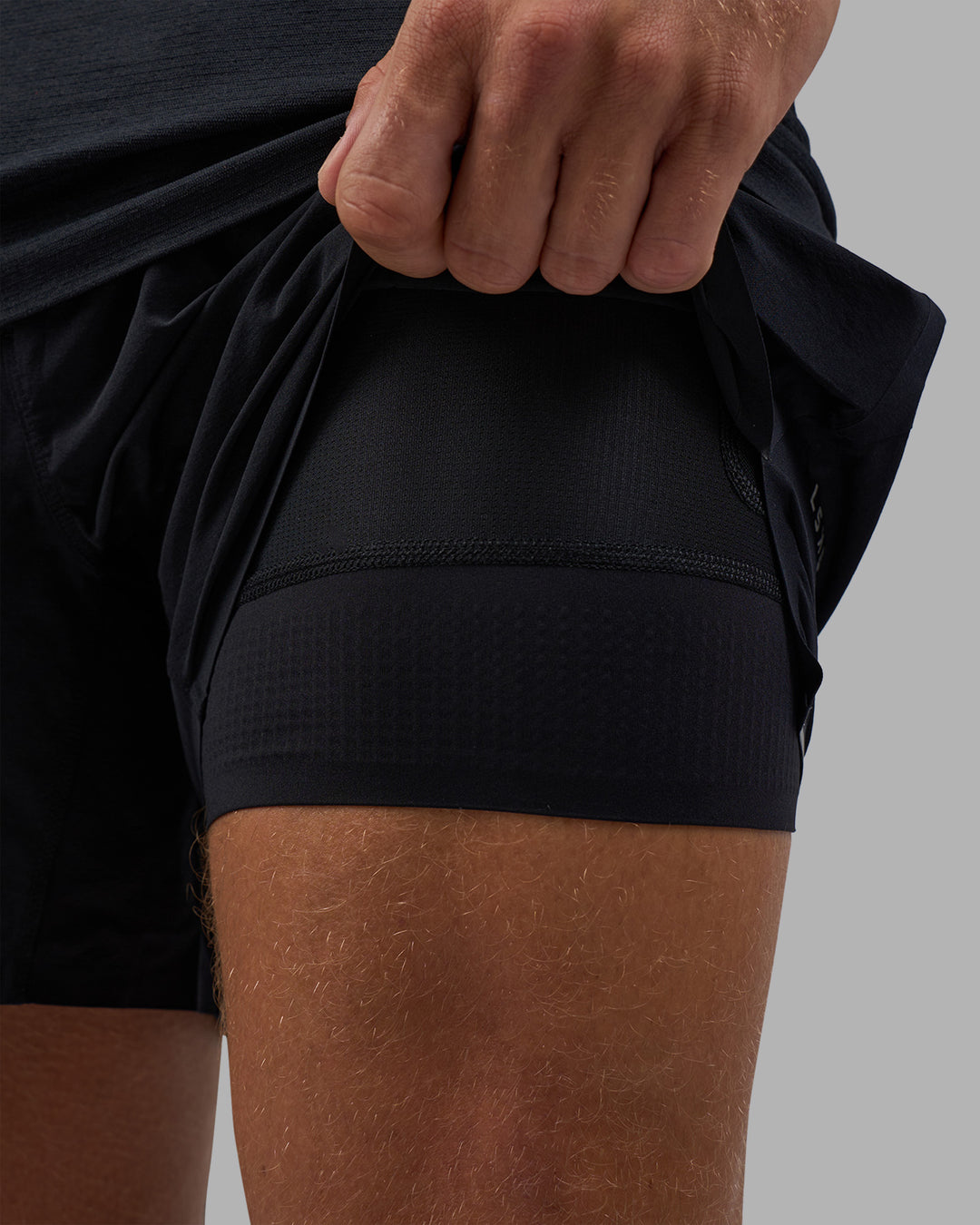 Man wearing Hybrid Lined 5&quot; Short - Black-Reflective | Model:Nikola | Size:L