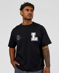 Man wearing Hype Heavyweight Unisex Oversized Tee - Black-White | Model:Xavier | Size:L | Thumbnail Index: 6