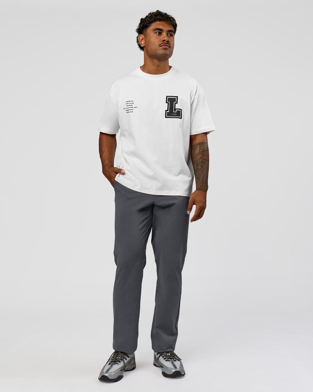 Man wearing Hype Heavyweight Unisex Oversized Tee - Off White-Black | Model:Xavier | Size:L