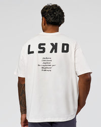 Man wearing Hype Heavyweight Unisex Oversized Tee - Off White-Black | Model:Xavier | Size:L
