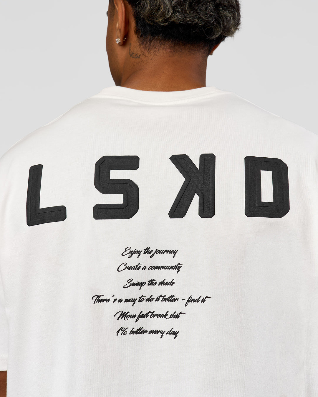 Man wearing Hype Heavyweight Unisex Oversized Tee - Off White-Black | Model:Xavier | Size:L