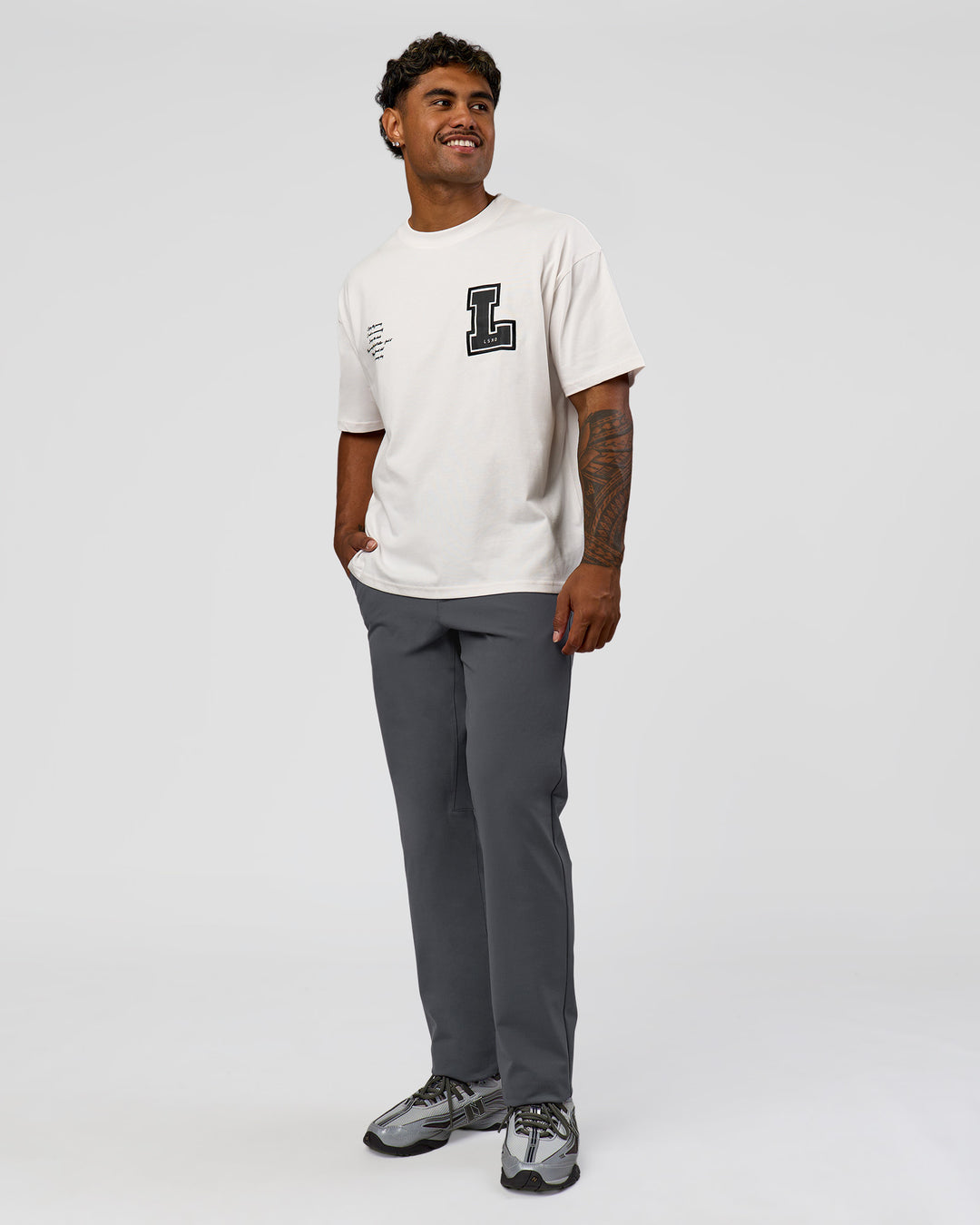 Man wearing Hype Heavyweight Unisex Oversized Tee - Off White-Black | Model:Xavier | Size:L
