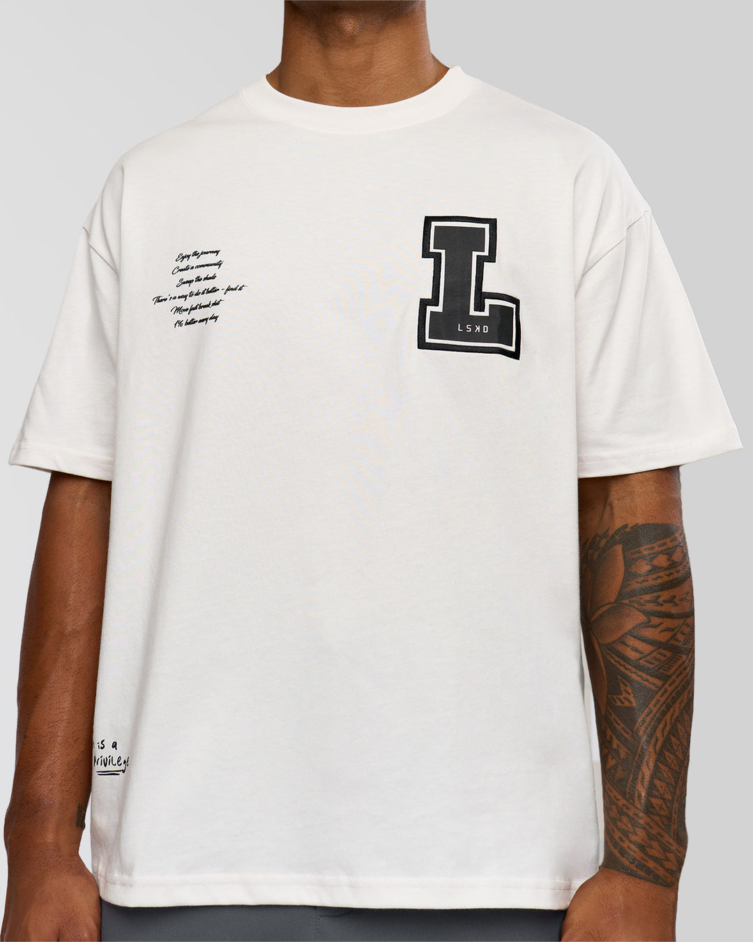 Man wearing Hype Heavyweight Unisex Oversized Tee - Off White-Black | Model:Xavier | Size:L