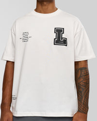Man wearing Hype Heavyweight Unisex Oversized Tee - Off White-Black | Model:Xavier | Size:L
