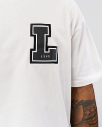 Man wearing Hype Heavyweight Unisex Oversized Tee - Off White-Black | Model:Xavier | Size:L