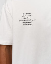 Man wearing Hype Heavyweight Unisex Oversized Tee - Off White-Black | Model:Xavier | Size:L