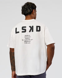 Man wearing Hype Heavyweight Unisex Oversized Tee - Off White-Black | Model:Xavier | Size:L