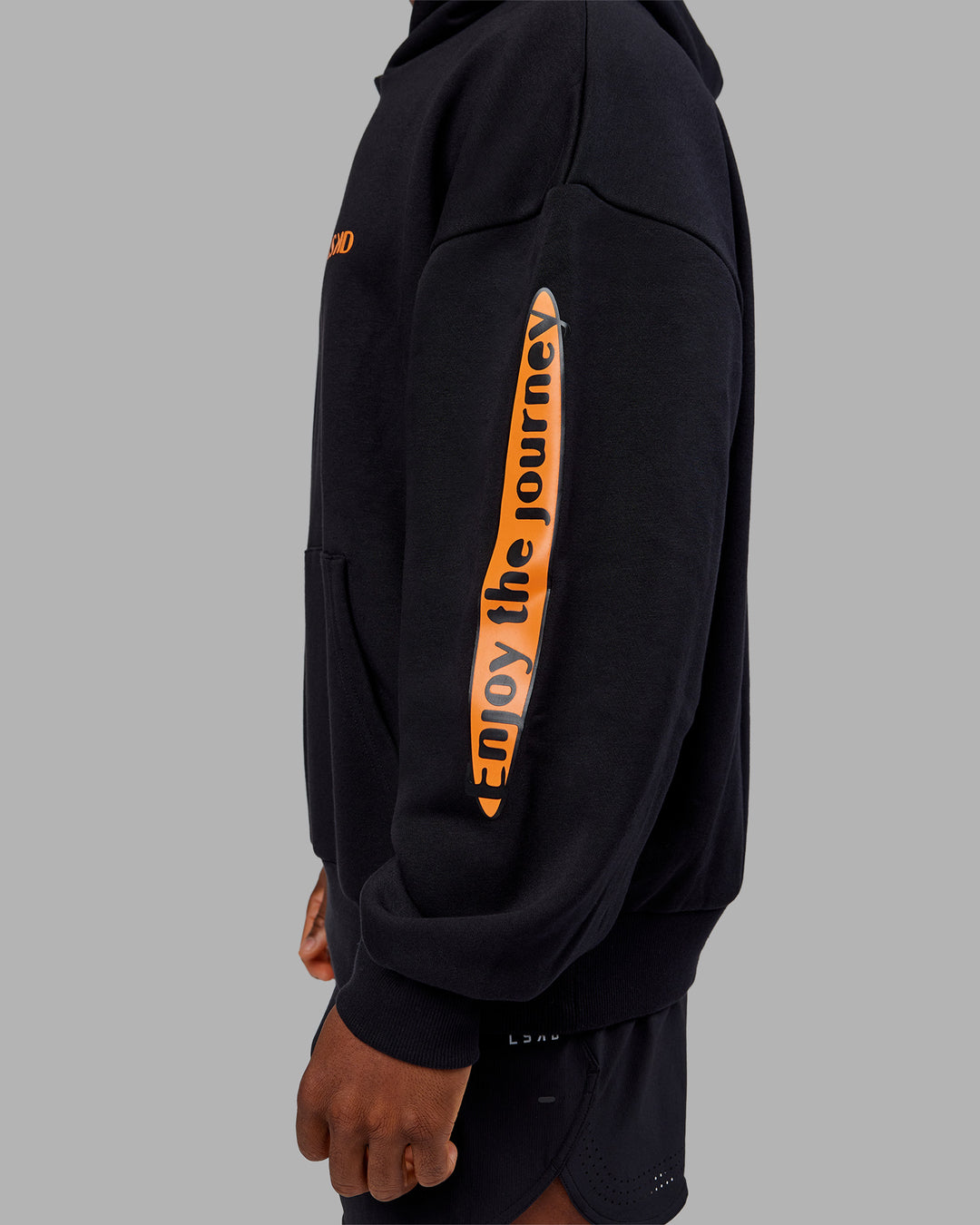 Man wearing Hyped Unisex Oversized Hoodie - Black-Vibrant Orange | Model:Sam | Size:L