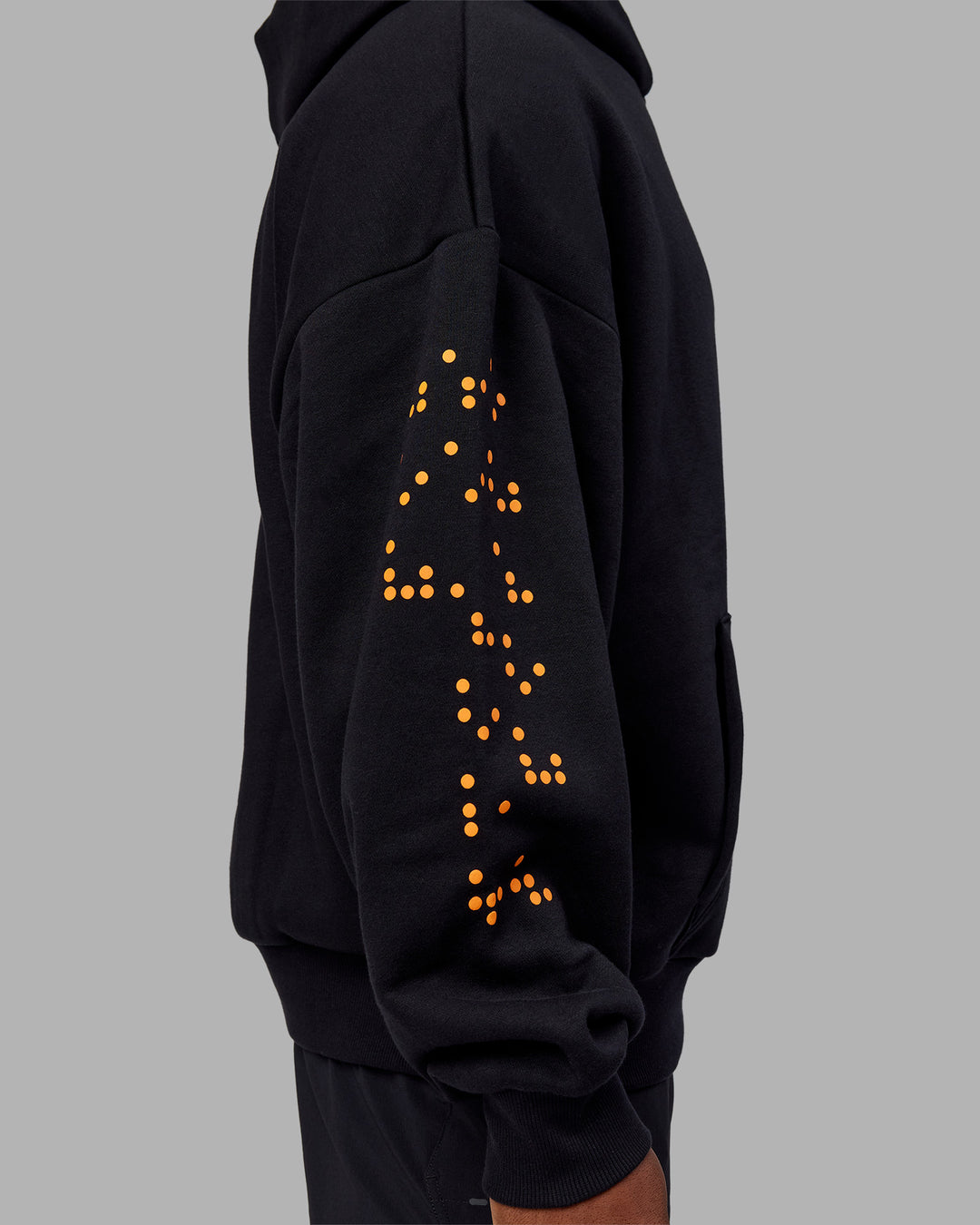 Man wearing Hyped Unisex Oversized Hoodie - Black-Vibrant Orange | Model:Sam | Size:L