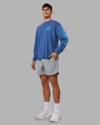 Man wearing Inferno Journey FLXCotton Oversized Long Sleeve Tee - Midnight Blue-Blue Bird | Model:Jackson | Size:L