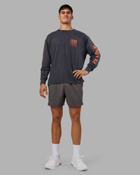 Man wearing Inferno Journey FLXCotton Oversized Long Sleeve Tee - Washed Black-Ultra Orange | Model:Jackson | Size:L