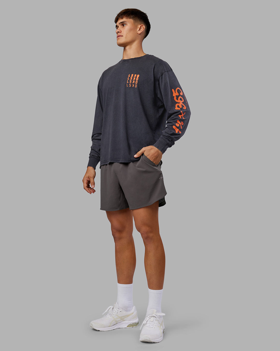 Man wearing Inferno Journey FLXCotton Oversized Long Sleeve Tee - Washed Black-Ultra Orange | Model:Jackson | Size:L