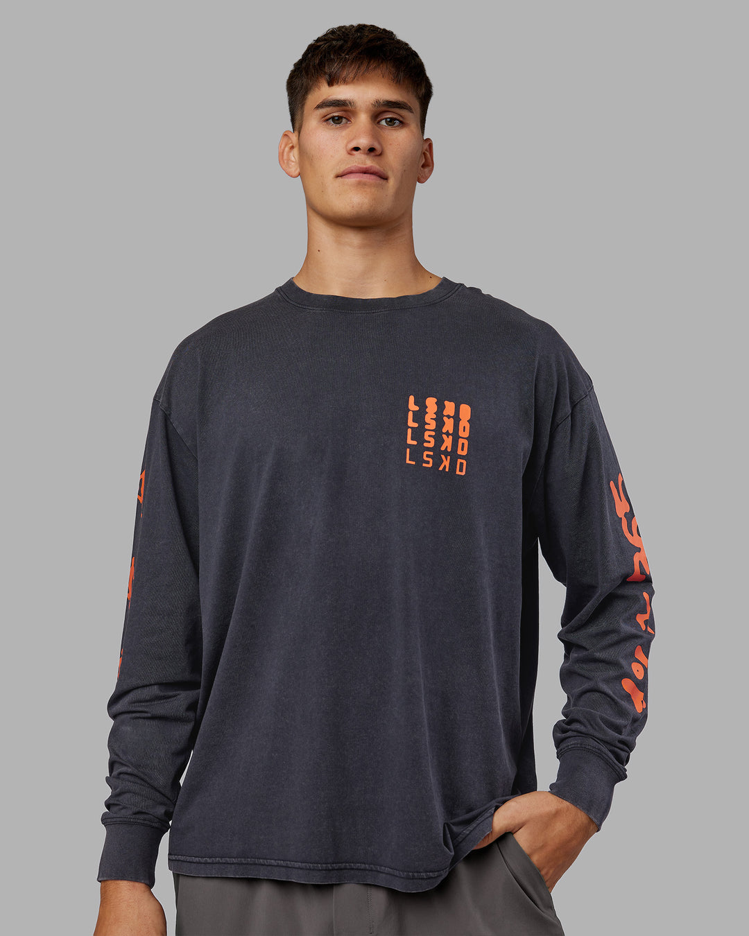 Man wearing Inferno Journey FLXCotton Oversized Long Sleeve Tee - Washed Black-Ultra Orange | Model:Jackson | Size:L
