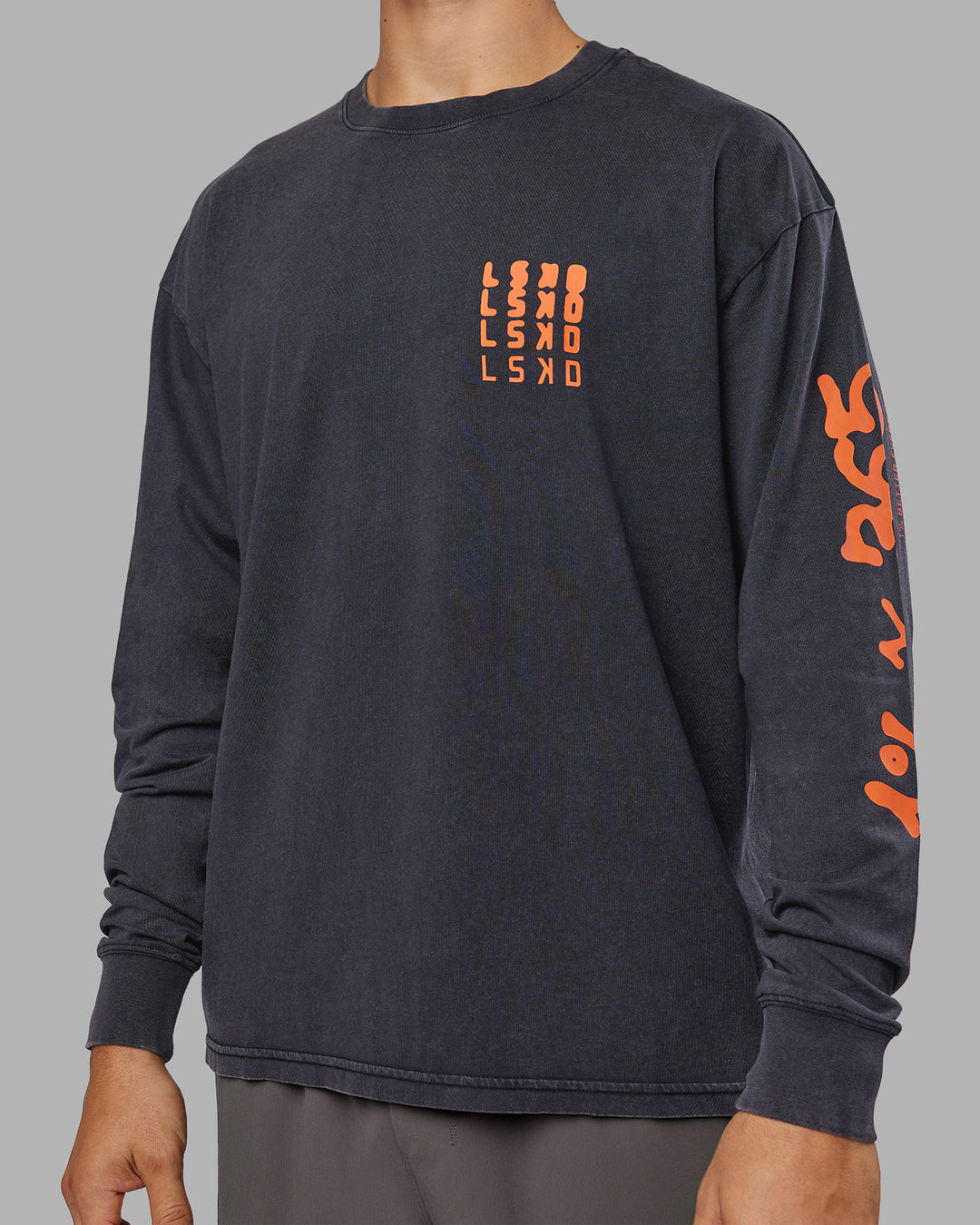 Man wearing Inferno Journey FLXCotton Oversized Long Sleeve Tee - Washed Black-Ultra Orange | Model:Jackson | Size:L