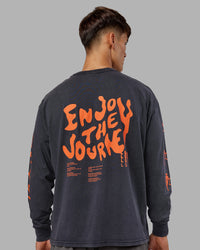 Man wearing Inferno Journey FLXCotton Oversized Long Sleeve Tee - Washed Black-Ultra Orange | Model:Jackson | Size:L