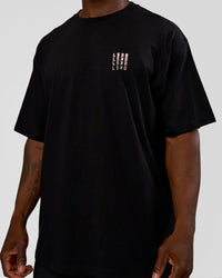 Man wearing Inferno Journey FLXCotton Oversized Tee - Black-Ultra Fuchsia | Model:Sam | Size:L