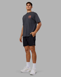 Man wearing Inferno Journey FLXCotton Oversized Tee - Black Washed-Ultra Orange | Model:Jackson | Size:L