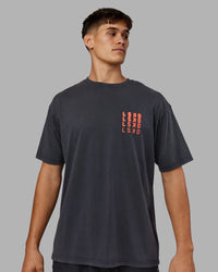 Man wearing Inferno Journey FLXCotton Oversized Tee - Black Washed-Ultra Orange | Model:Jackson | Size:L
