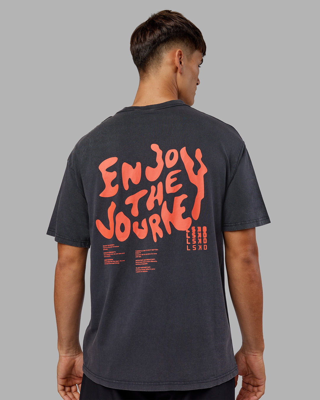 Man wearing Inferno Journey FLXCotton Oversized Tee - Black Washed-Ultra Orange | Model:Jackson | Size:L