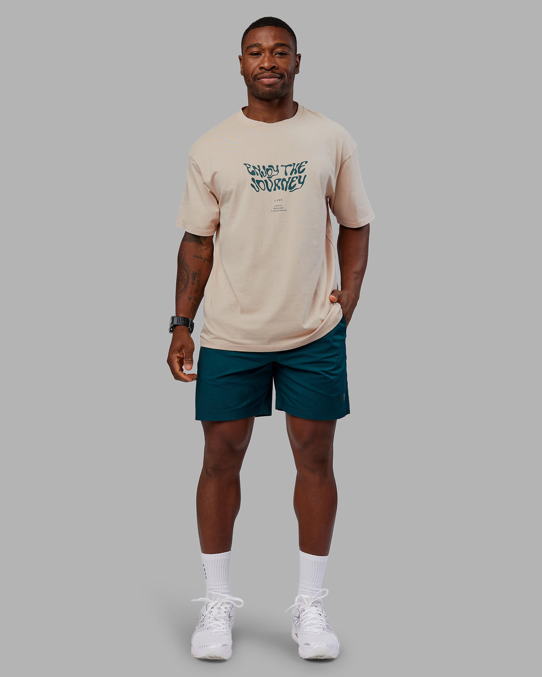 Man wearing Journey FLXCotton Oversized Tee - Washed Shale Beige-Dark Moss| Model:Sam | Size:L