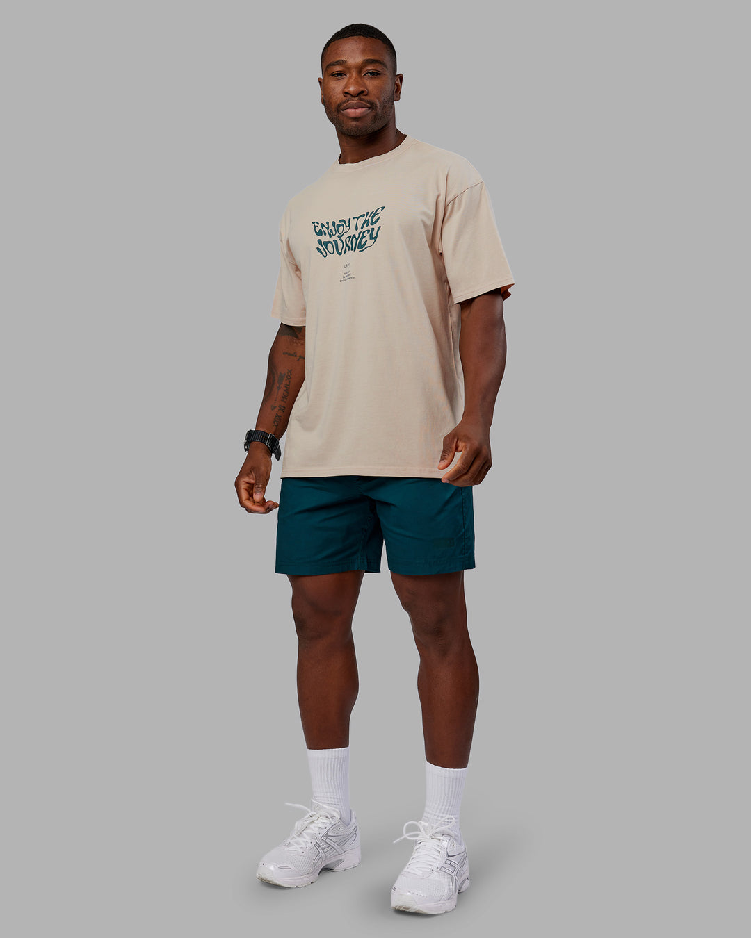 Man wearing Journey FLXCotton Oversized Tee - Washed Shale Beige-Dark Moss| Model:Sam | Size:L