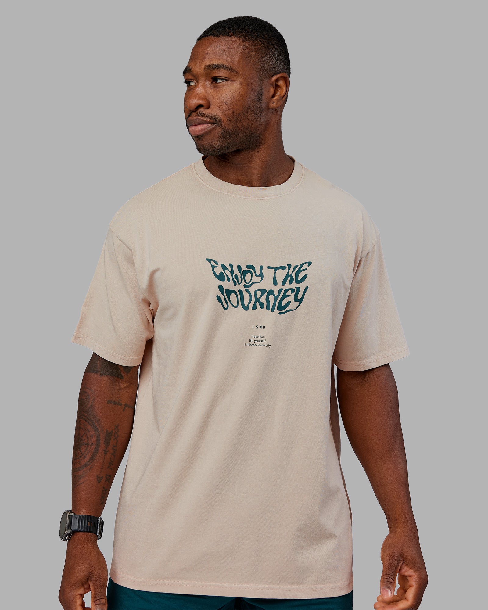 Man wearing Journey FLXCotton Oversized Tee - Washed Shale Beige-Dark Moss| Model:Sam | Size:L