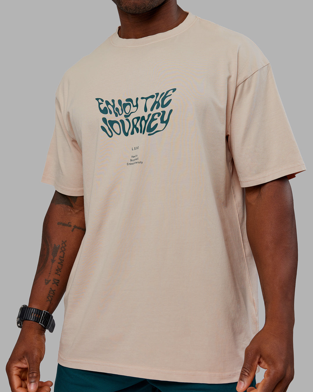 Man wearing Journey FLXCotton Oversized Tee - Washed Shale Beige-Dark Moss| Model:Sam | Size:L