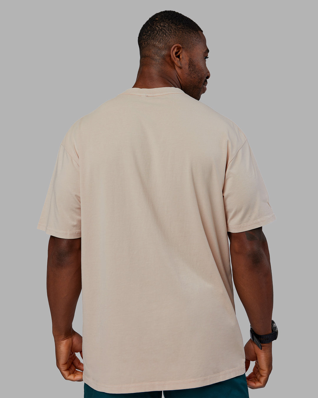 Man wearing Journey FLXCotton Oversized Tee - Washed Shale Beige-Dark Moss| Model:Sam | Size:L