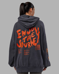Woman wearing Journey Washed Unisex Oversize Hoodie - Black-Ultra Orange | Model:Rhiley | Size:L