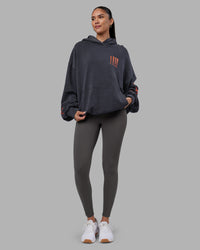 Woman wearing Journey Washed Unisex Oversize Hoodie - Black-Ultra Orange | Model:Rhiley | Size:L