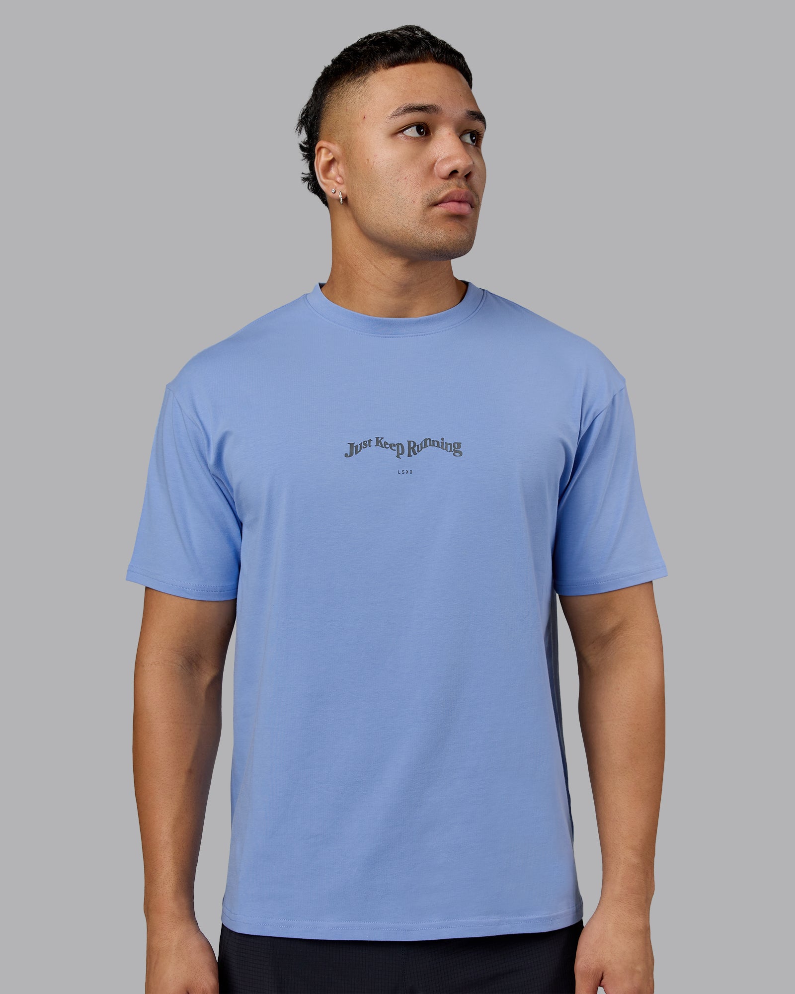Man wearing Just Run FLXCotton Oversized Tee - Soft Blue-Dark Storm | Model:Kaelyb | Size:L
