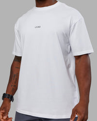Man wearing Kettlebell FLXCotton Oversized Tee - White-Black | Model:Sam | Size:L